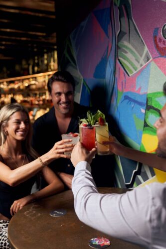 Young people having cocktail on rooftop bar in Fort Lauderdale